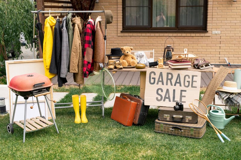 Organise a successfule garage sale. Items displayed on the lawn.